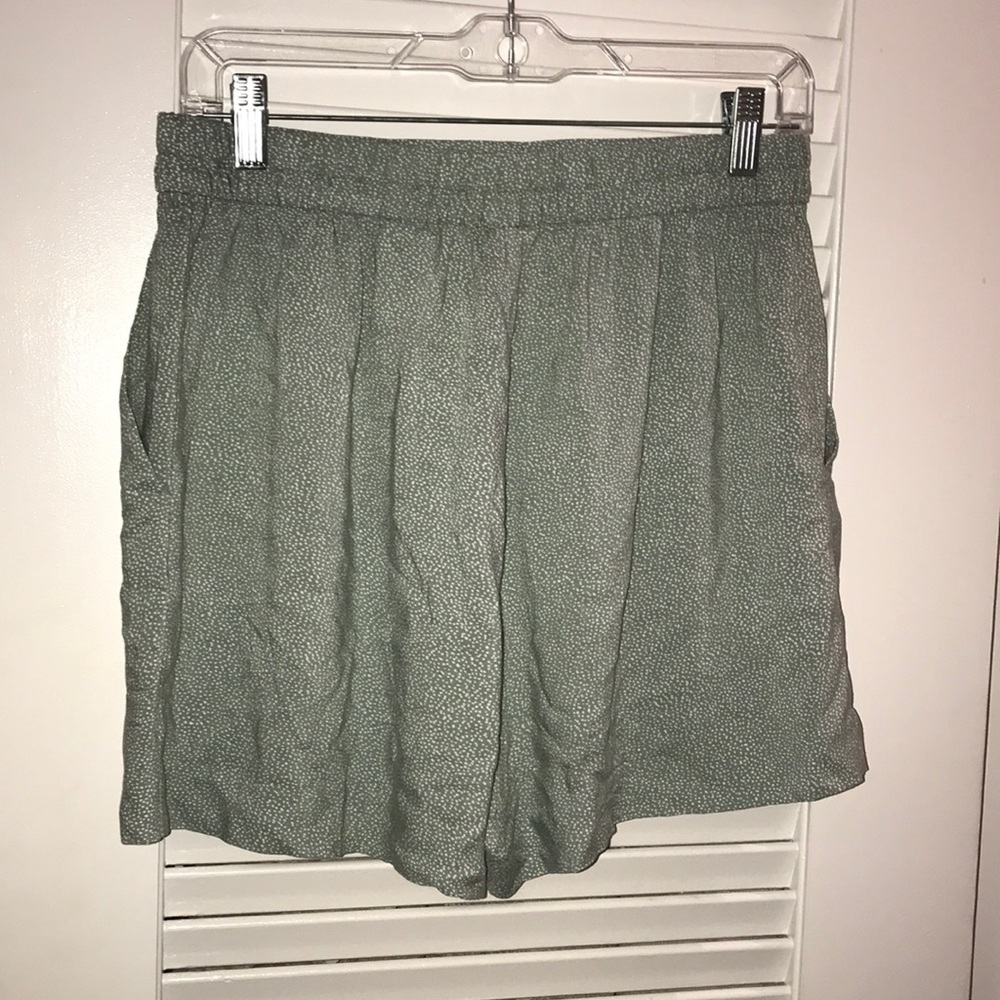 Green high waisted shorts with white specks